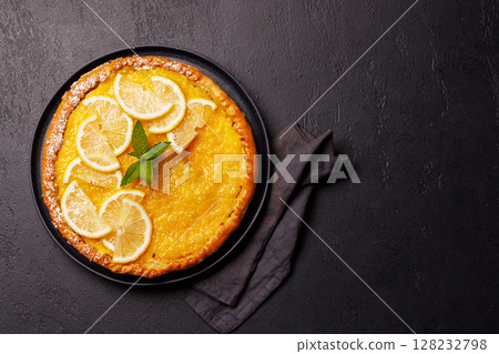 Delicious lemon tart with golden crust and smooth, glossy lemon filling 128232798