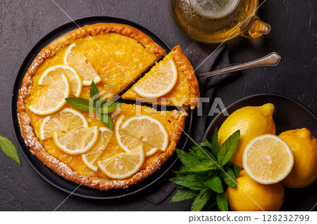 Delicious lemon tart with golden crust and smooth, glossy lemon filling 128232799