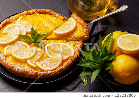 Delicious lemon tart with golden crust and smooth, glossy lemon filling 128232800
