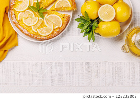 Delicious lemon tart with golden crust and smooth, glossy lemon filling 128232802