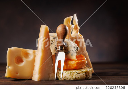 Assorted cheeses in different shapes and textures displayed together 128232806