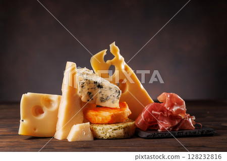 Assorted cheeses in different shapes and textures displayed together 128232816