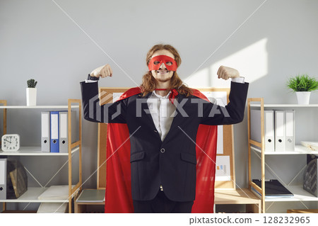 Funny office worker in red superhero mask and cape demonstrating can-do attitude 128232965