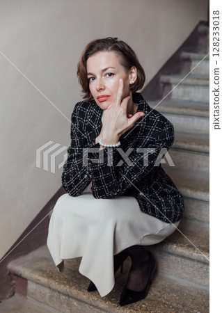 Portrait of a beautiful woman in a skirt and jacket 128233018