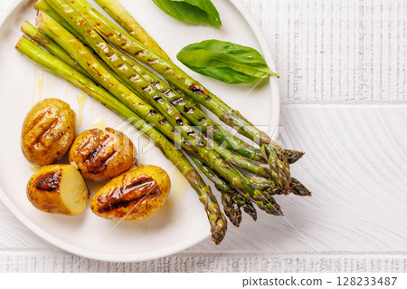 Grilled asparagus and golden baby potatoes Grilled asparagus and golden baby potatoes 128233487
