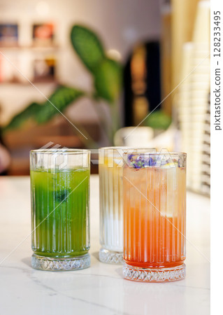 Assorted summer lemonades in glass jars with fresh fruits, ice, and garnishes Assorted summer lemonades in glass jars with fresh fruits, ice, and garnishes 128233495