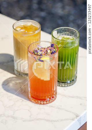 Assorted summer lemonades in glass jars with fresh fruits, ice, and garnishes Assorted summer lemonades in glass jars with fresh fruits, ice, and garnishes 128233497