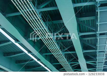 industrial background, view from below of the bridge supporting beams industrial background, view from below of the bridge supporting beams 128233838