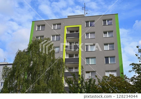 Original prefabricated houses on a housing estate from the communist era in Eastern and Central Europe after reconstruction.. Facade of a modern apartment building with windows and balconies. Czech Original prefabricated houses on a housing estate from the communist era in Eastern and Central Europe after reconstruction.. Facade of a modern apartment building with windows and balconies. Czech 128234044