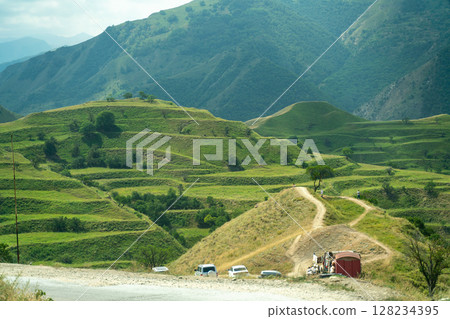 A mountain range with a red building in the middle A mountain range with a red building in the middle 128234395