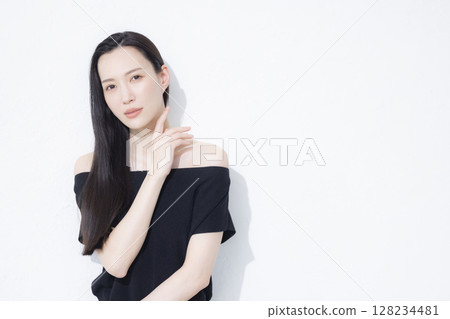 A woman wearing a black off-the-shoulder A woman wearing a black off-the-shoulder 128234481