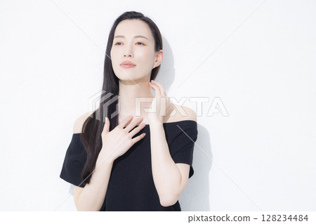 A woman wearing a black off-the-shoulder A woman wearing a black off-the-shoulder 128234484