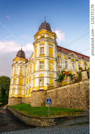 uzhhorod, ukraine - 9 jul 2012: exterior of holy cross greek catholic cathedral on the hill in evening light. beautiful baroque style architecture. prominent religious landmark of europe uzhhorod, ukraine - 9 jul 2012: exterior of holy cross greek catholic cathedral on the hill in evening light. beautiful baroque style architecture. prominent religious landmark of europe 128235176