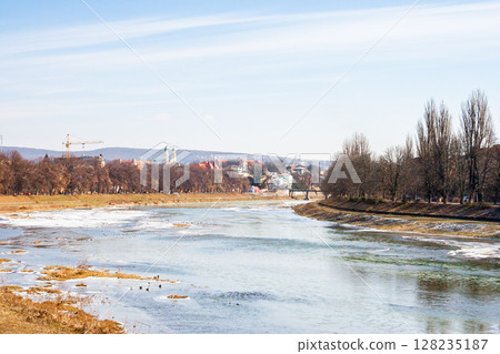 uzhhorod, ukraine - 17 feb, 2008: uzh river in winter. scenic view. beautiful urban scenery. cityscape on a frosty sunny day. white season 128235187