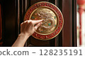 hand holding a tray of bitcoin 128235191