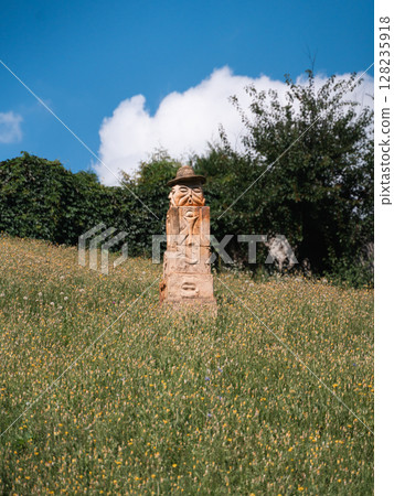 Stone sculpture representing pagan traditions in Opishnia, Poltava, Ukraine amidst lush greenery and 128235918
