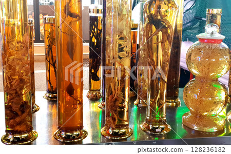 Ginseng in a bottle. Ginseng from Korea mixed with soju water in a bottle. Ginseng in a bottle. Ginseng from Korea mixed with soju water in a bottle. 128236182