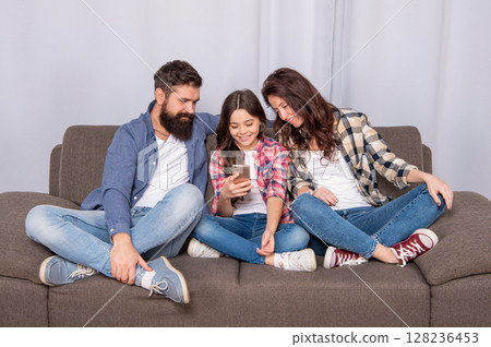 Connect and chat. Happy daughter chatting in smartphone. Family chat. Parental control Connect and chat. Happy daughter chatting in smartphone. Family chat. Parental control 128236453