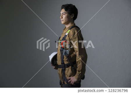 Male worker wearing a full harness 128236796