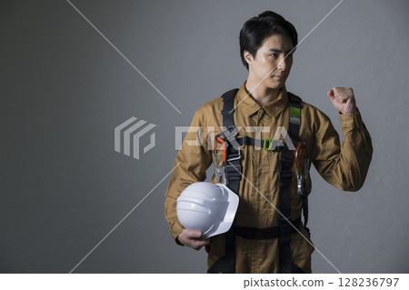 Male worker wearing a full harness 128236797