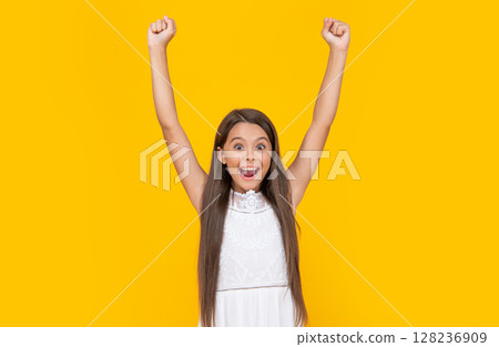 successful teen kid in white dress has long hair on yellow background 128236909
