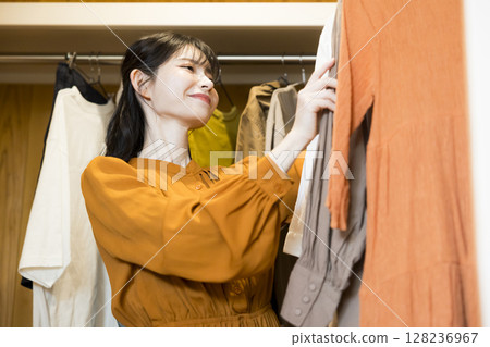 A woman choosing clothes 128236967