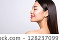 A woman with natural make-up and shiny skin that reflects light. A close-up of her face, a beauty image. 128237099
