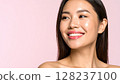 A woman with natural make-up and shiny skin that reflects light. A close-up of her face, a beauty image. 128237100