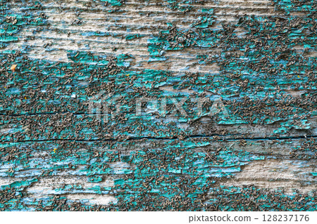 Textured weathered wood with peeling turquoise paint 128237176
