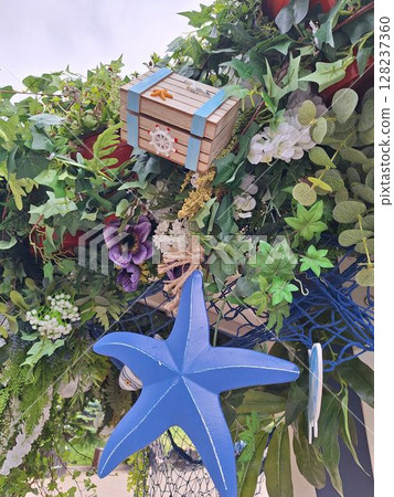 Vibrant nautical-themed decor with sea star and foliage Vibrant nautical-themed decor with sea star and foliage 128237360
