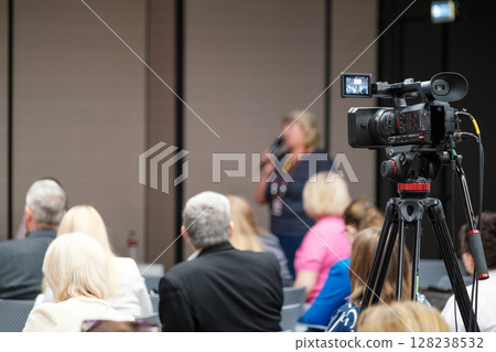 Professional video recording at live business conference event with audience Professional video recording at live business conference event with audience 128238532