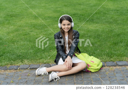 Student life. Listen to music in headphones. Teenage girl generation listen audio. Lifestyle concept. Back to school. School education. Teen girl school student listen music outdoor. Modern lifestyle Student life. Listen to music in headphones. Teenage girl generation listen audio. Lifestyle concept. Back to school. School education. Teen girl school student listen music outdoor. Modern lifestyle 128238546