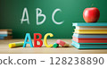 Red apple, books and letter A, B, C on a  background of a school board. The concept of primary education.  128238890