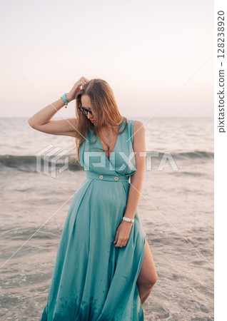 Woman in Flowing Dress on Seaside Pier Woman in Flowing Dress on Seaside Pier 128238920