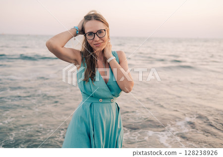 Woman in Flowing Dress on Seaside Pier Woman in Flowing Dress on Seaside Pier 128238926