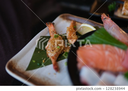 Sushi Set nigiri and sushi rolls with tea served on gray stone slate on metal background 128238944