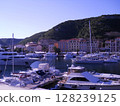 Stunning panoramic view of Bonifacio, a luxurious seaside resort in Carsica, France. The image features a picturesque harbor filled with elegant white yachts. 128239125