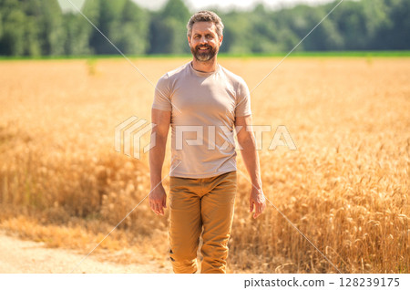 Hispanic man farmer check agriculture field harvest. Man agronomist farmer. Crop protection. Agriculture farm. Farm man at wheat field. Crop harvest and farming. Farmer in field 128239175