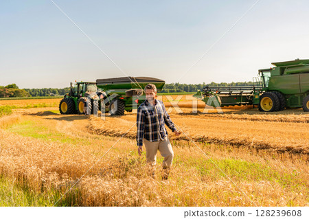 Farmer agronomist. Crop harvest. Farmer check wheat. Agricultural wheat harvest. Countryside crop. Agronomist man harvesting at crop field. Ripe agriculture. Harvest man at field. Sustainable farming Farmer agronomist. Crop harvest. Farmer check wheat. Agricultural wheat harvest. Countryside crop. Agronomist man harvesting at crop field. Ripe agriculture. Harvest man at field. Sustainable farming 128239608