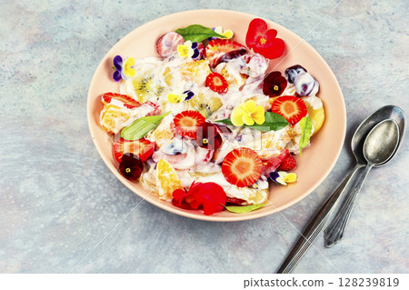 Fruit salad decorated with flowers. Fruit salad decorated with flowers. 128239819