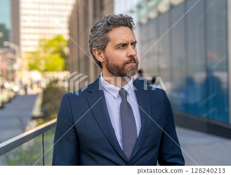 Business success man outdoor. Businessman before business successful meeting in city. Business success of businessman. Businessman in suit. Top manager, Investment banker. Rich man in suit 128240213