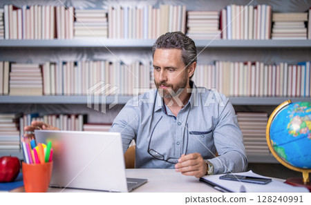 teacher at lesson during estudy. digital classroom. Online education of teacher in classroom. teachers day. teacher man offer education online. online school education. Online tutoring teacher at lesson during estudy. digital classroom. Online education of teacher in classroom. teachers day. teacher man offer education online. online school education. Online tutoring 128240991