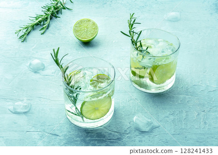 Gin tonic, two glasses of gin with soda, lime, rosemary, and plenty of ice Gin tonic, two glasses of gin with soda, lime, rosemary, and plenty of ice 128241433