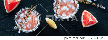 Salty Dog cocktail with fresh grapefruit juice, lime juice, and thyme panorama 128241442