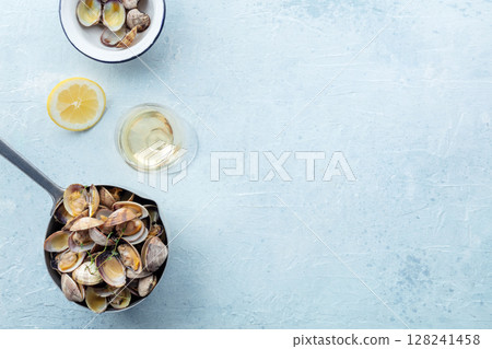 Vongole clams in a sauce pan, overhead flat lay shot with lemon and thyme 128241458
