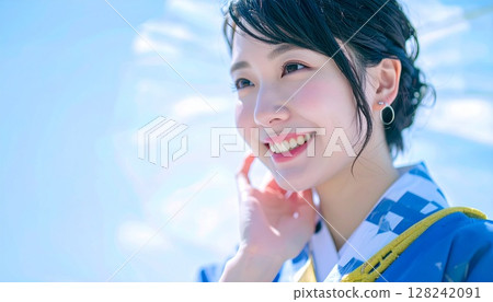 A woman in a yukata looking up at the sky A woman in a yukata looking up at the sky 128242091