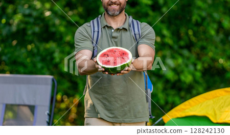Man with watermelon in summer camping. Man hiker outdoor on summer day. Summer camp and nature picnic. Man on summer camping. Camp watermelon food. Yummy healthy food. Fresh food in camp Man with watermelon in summer camping. Man hiker outdoor on summer day. Summer camp and nature picnic. Man on summer camping. Camp watermelon food. Yummy healthy food. Fresh food in camp 128242130