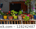 Multicolored geraniums in pots on the porch 128242487
