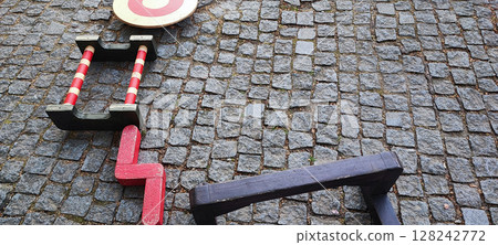 Colorful Wooden Playground Stepping Blocks on Cobblestone Street. Urban Outdoor Kids Game. Concept of child development, learning, in urban living conditions Colorful Wooden Playground Stepping Blocks on Cobblestone Street. Urban Outdoor Kids Game. Concept of child development, learning, in urban living conditions 128242772