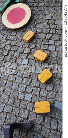 Colorful Wooden Playground Stepping Blocks on Cobblestone Street. Urban Outdoor Kids Game. Concept of child development, learning, in urban living conditions Colorful Wooden Playground Stepping Blocks on Cobblestone Street. Urban Outdoor Kids Game. Concept of child development, learning, in urban living conditions 128242773